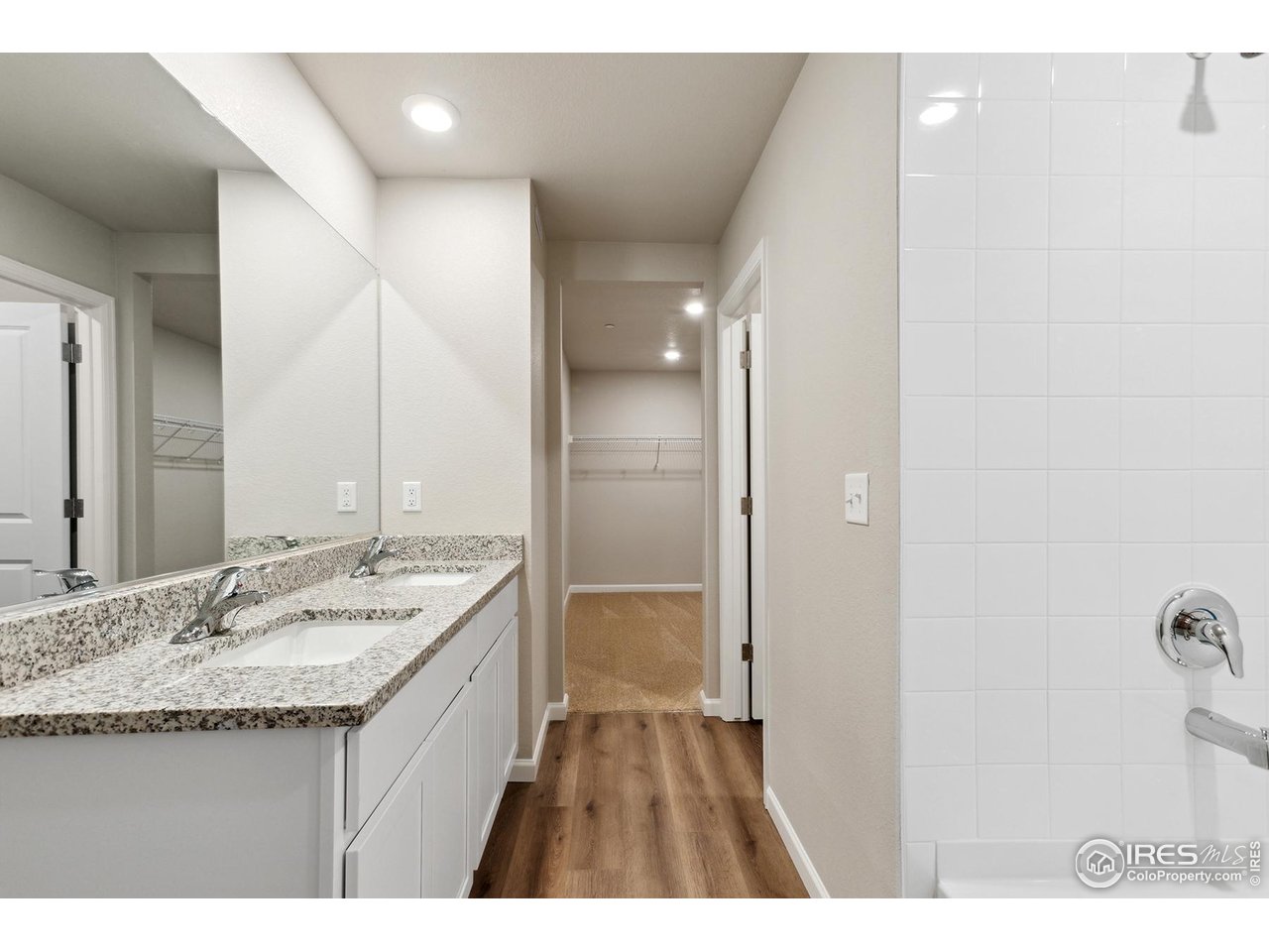 199 Robin Road Johnstown, CO 80534 - Photo 13 of 30 a bathroom with a granite countertop sink mirror and a
