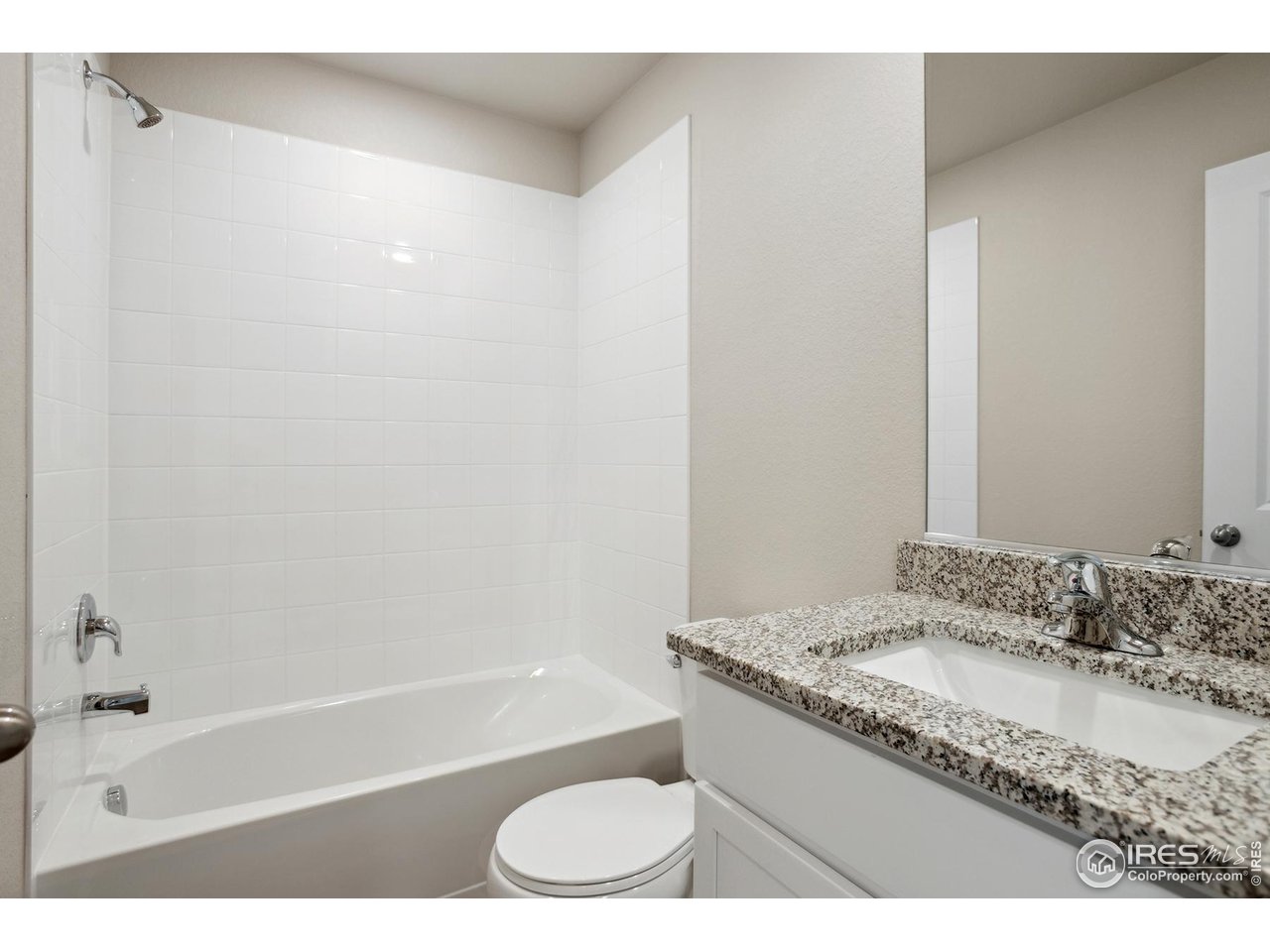 199 Robin Road Johnstown, CO 80534 - Photo 16 of 30 a bathroom with a granite countertop sink a toilet and bathtub