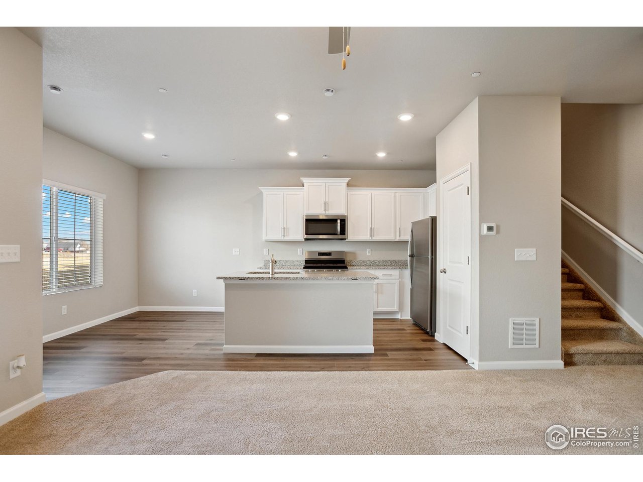 199 Robin Road Johnstown, CO 80534 - Photo 5 of 30 a view of kitchen with kitchen island granite countertop refrigerator stove top oven and cabinets