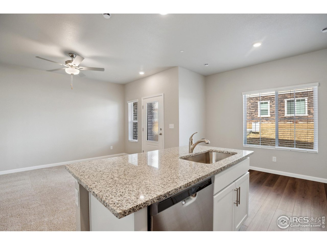 199 Robin Road Johnstown, CO 80534 - Photo 8 of 30 a kitchen with granite countertop a sink and a window