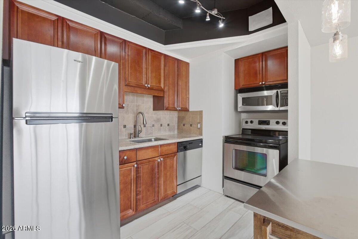 4750 North Central Avenue, Unit B14 Phoenix, AZ 85012 - Photo 10 of 57 a kitchen with stainless steel appliances granite countertop a refrigerator sink and stove