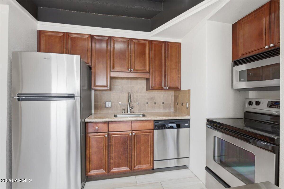 4750 North Central Avenue, Unit B14 Phoenix, AZ 85012 - Photo 11 of 57 a kitchen with a refrigerator sink and cabinets