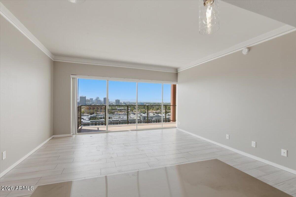 4750 North Central Avenue, Unit B14 Phoenix, AZ 85012 - Photo 13 of 57 an empty room with wooden floor and windows