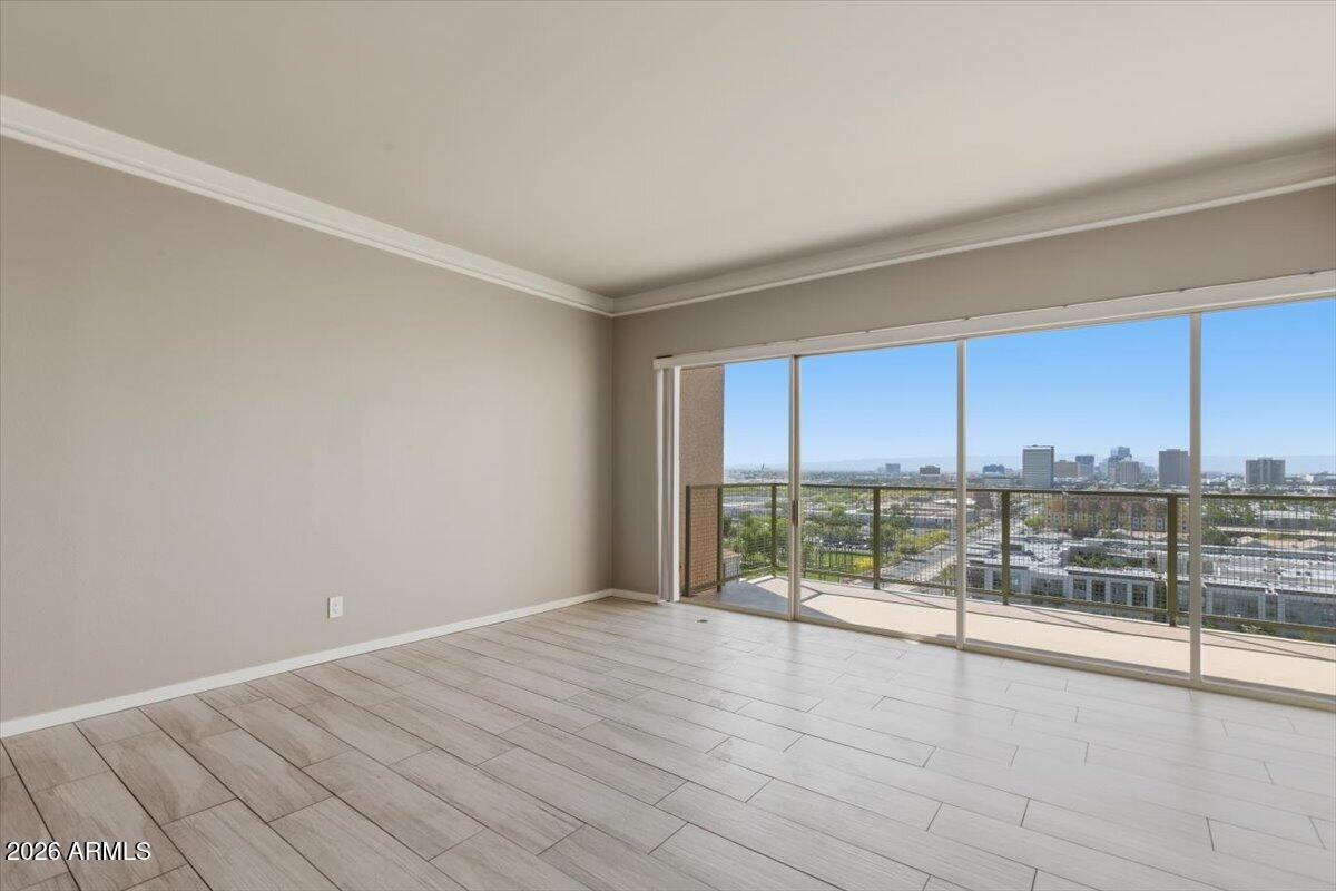 4750 North Central Avenue, Unit B14 Phoenix, AZ 85012 - Photo 14 of 57 an empty room with wooden floor and windows