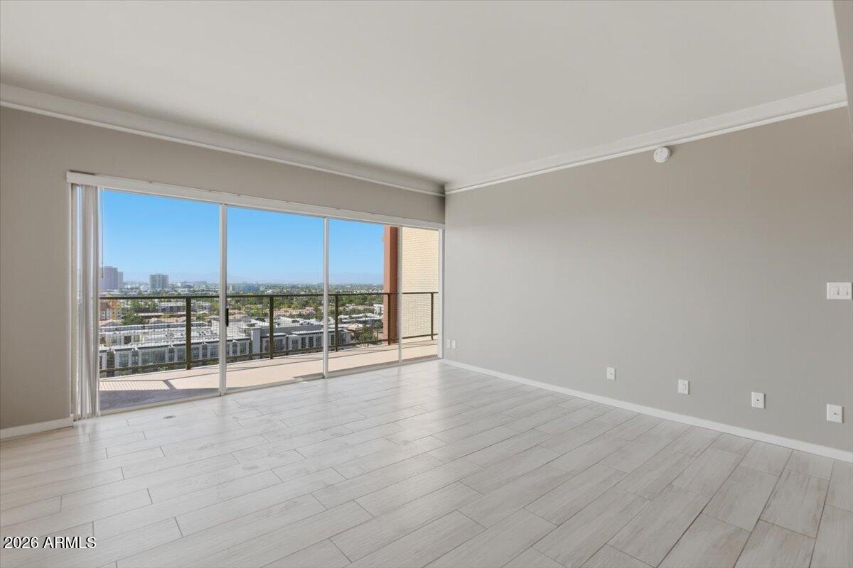 4750 North Central Avenue, Unit B14 Phoenix, AZ 85012 - Photo 16 of 57 a view of an empty room with wooden floor and a window