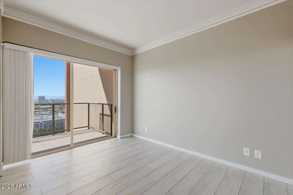 4750 North Central Avenue, Unit B14 Phoenix, AZ 85012 - Photo 20 of 57 an empty room with wooden floor and windows