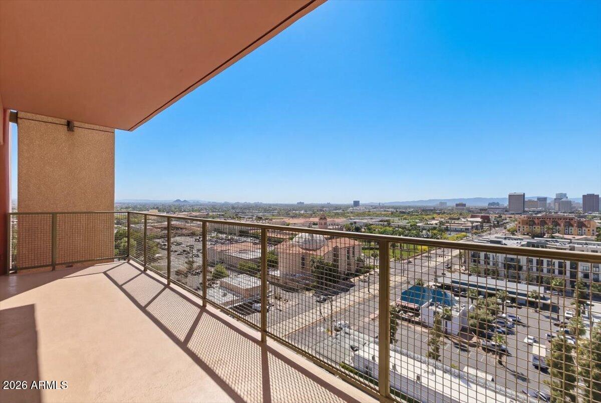 4750 North Central Avenue, Unit B14 Phoenix, AZ 85012 - Photo 22 of 57 a view of a balcony with wooden floor and city view