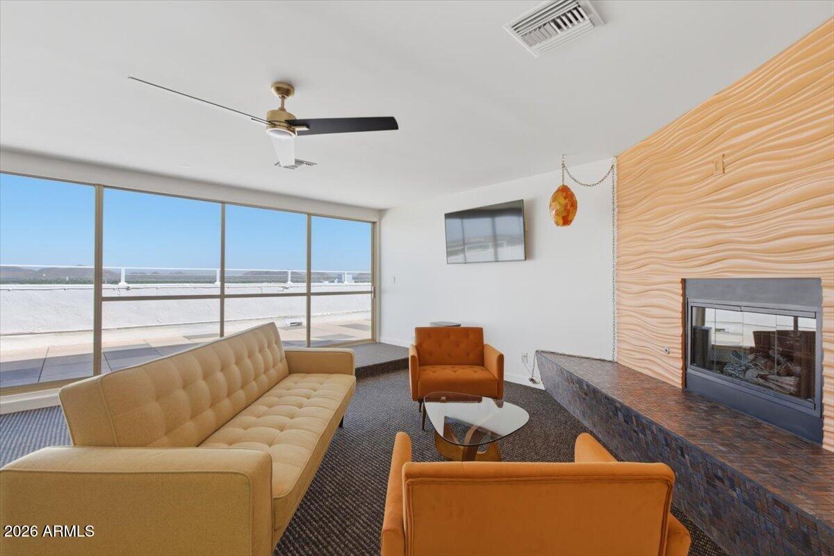 4750 North Central Avenue, Unit B14 Phoenix, AZ 85012 - Photo 32 of 57 a living room with furniture and a fireplace