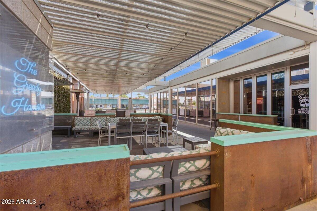 4750 North Central Avenue, Unit B14 Phoenix, AZ 85012 - Photo 3 of 57 a view of a patio with table and chairs and wooden fence