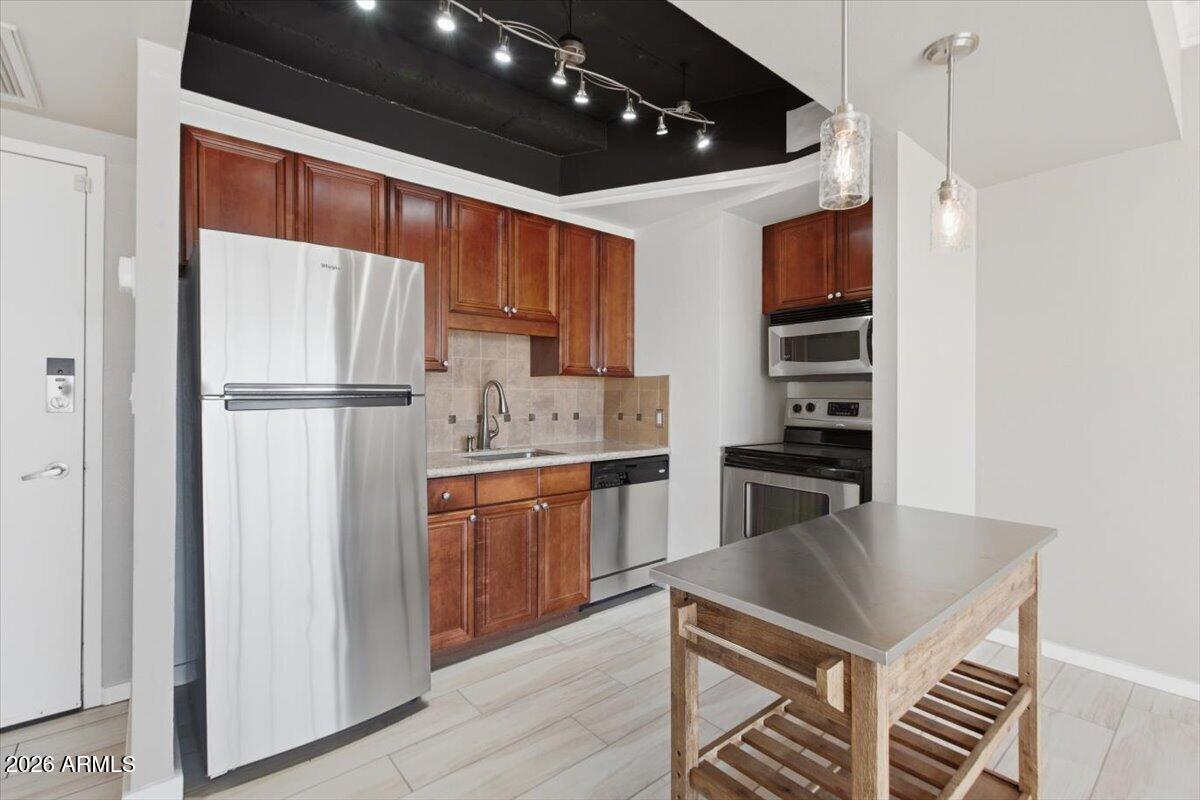 4750 North Central Avenue, Unit B14 Phoenix, AZ 85012 - Photo 8 of 57 a kitchen with stainless steel appliances a refrigerator and a stove top oven