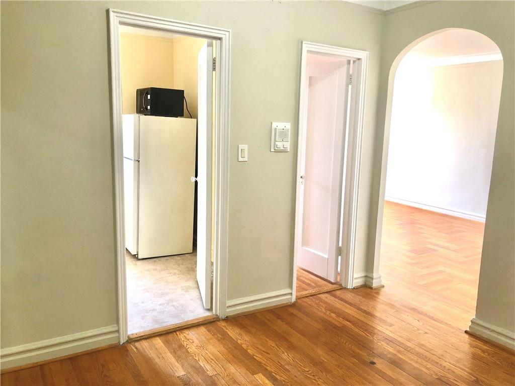 1900 Quentin Road, Unit E5 Brooklyn, NY 11229 - Photo 6 of 17 an empty room with wooden floor and a bathroom