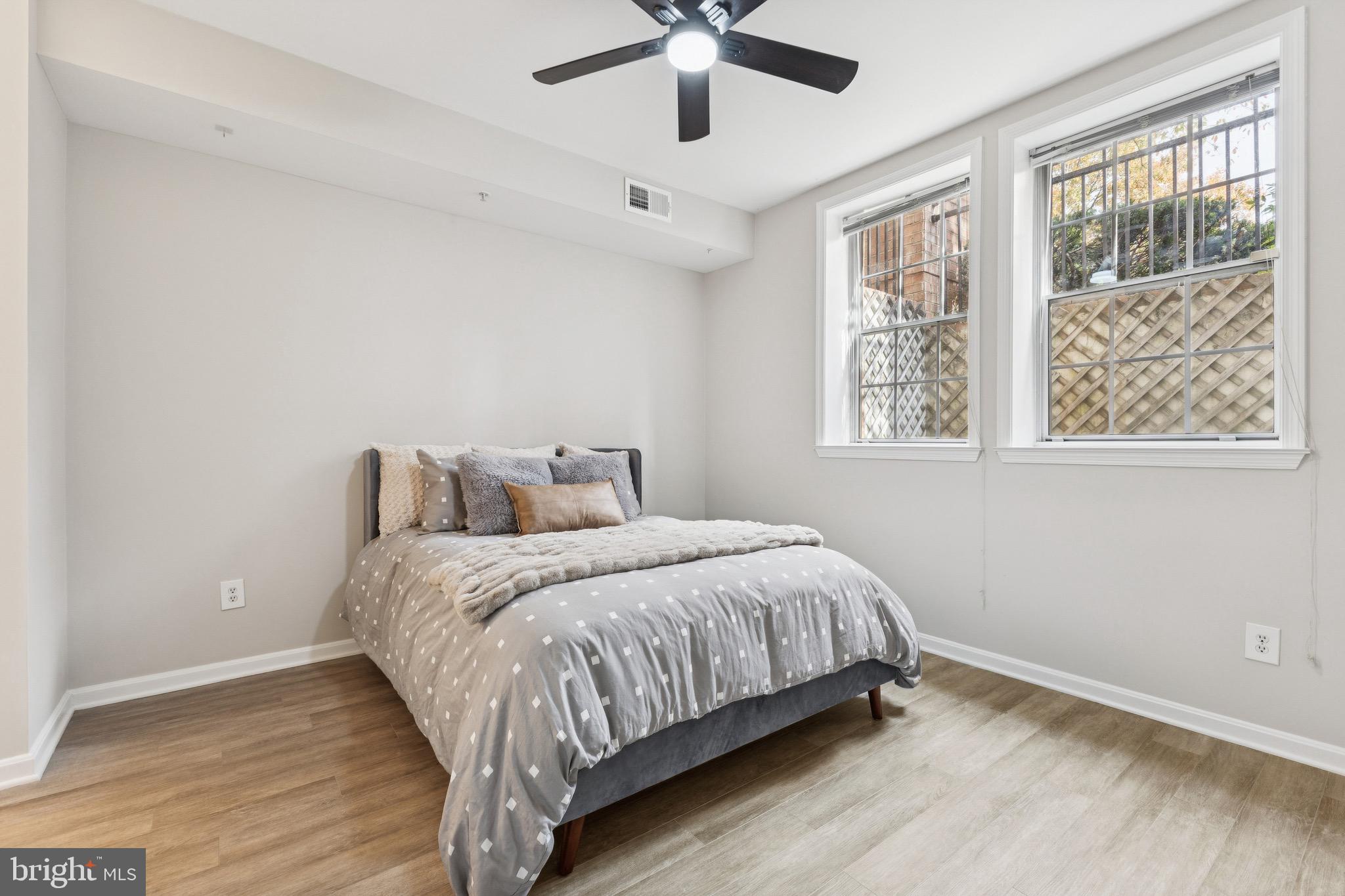 1361 Garden Wall Circle, Unit 701 Reston, VA 20194 - Photo 12 of 15 a bedroom with a bed and window
