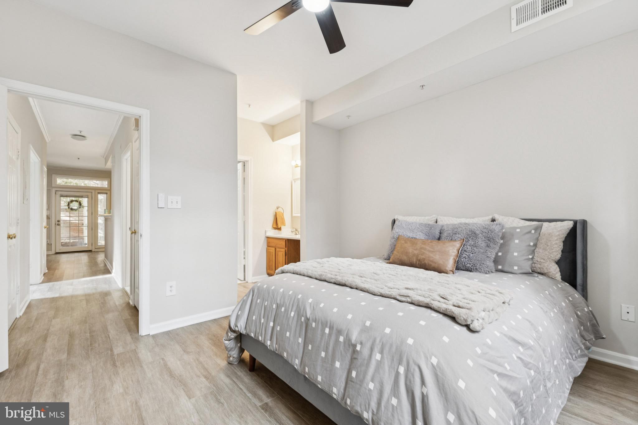 1361 Garden Wall Circle, Unit 701 Reston, VA 20194 - Photo 13 of 15 a bedroom with a bed and wooden floor