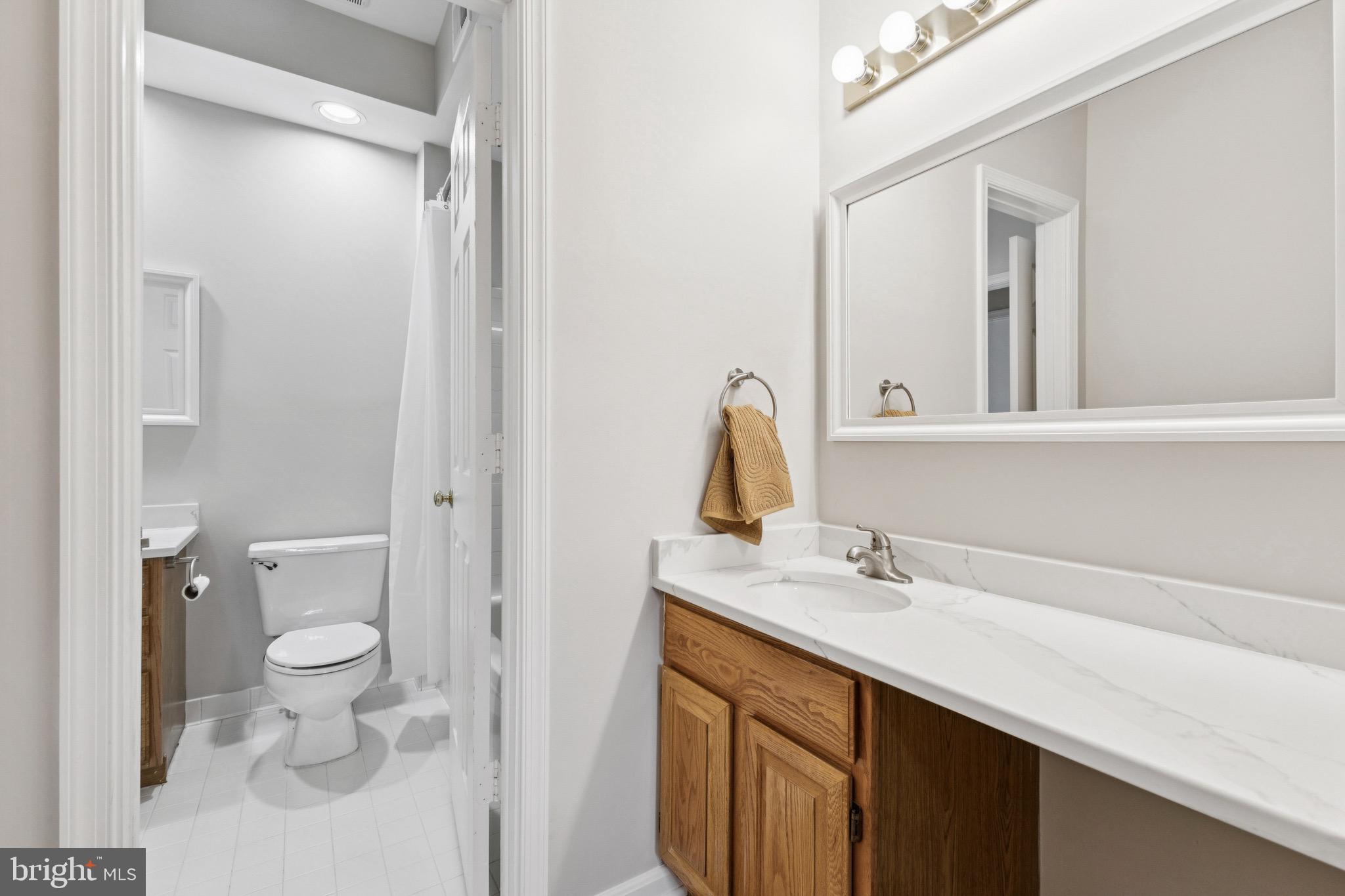 1361 Garden Wall Circle, Unit 701 Reston, VA 20194 - Photo 14 of 15 a bathroom with a sink and a mirror