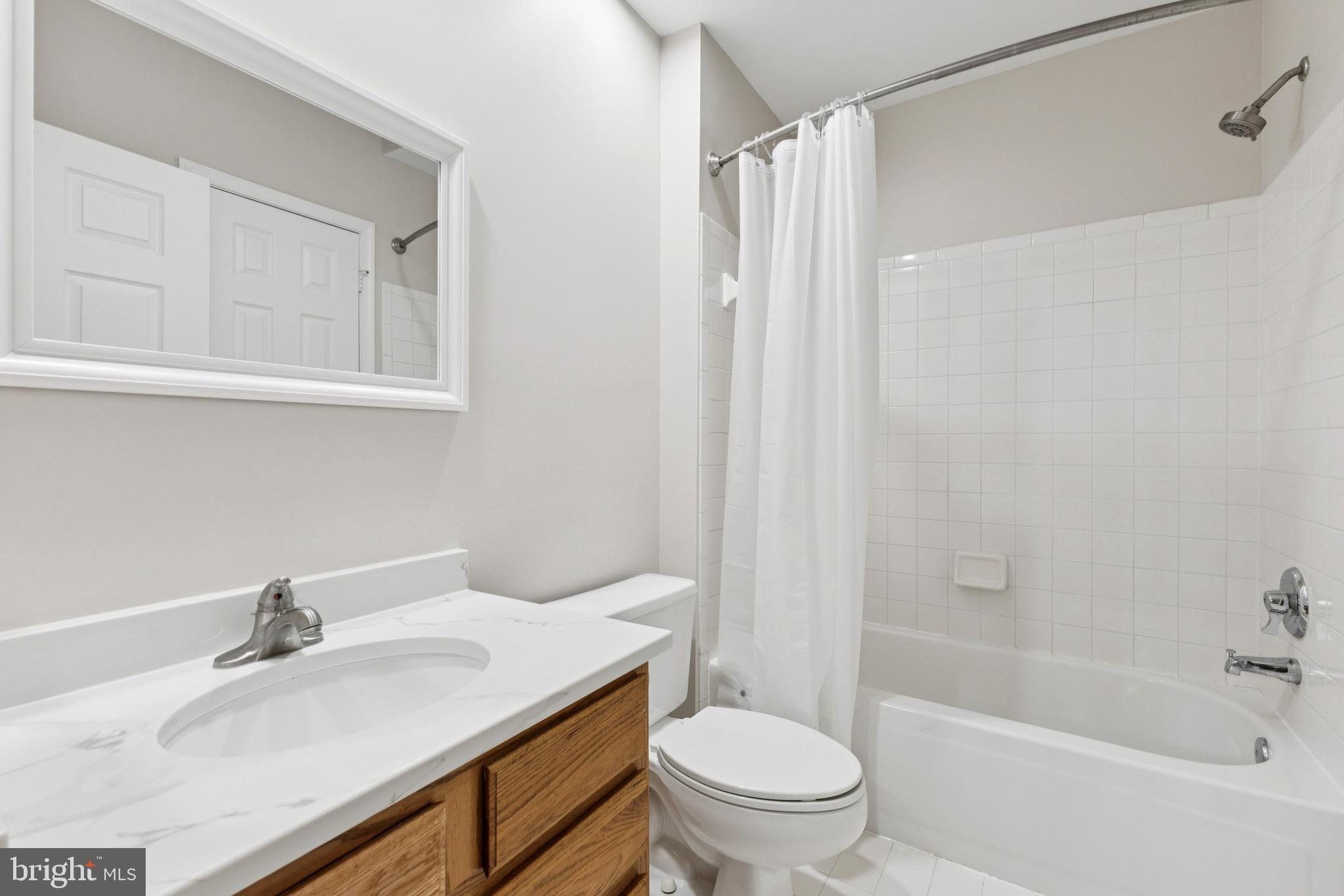 1361 Garden Wall Circle, Unit 701 Reston, VA 20194 - Photo 15 of 15 a bathroom with a granite countertop sink toilet and shower