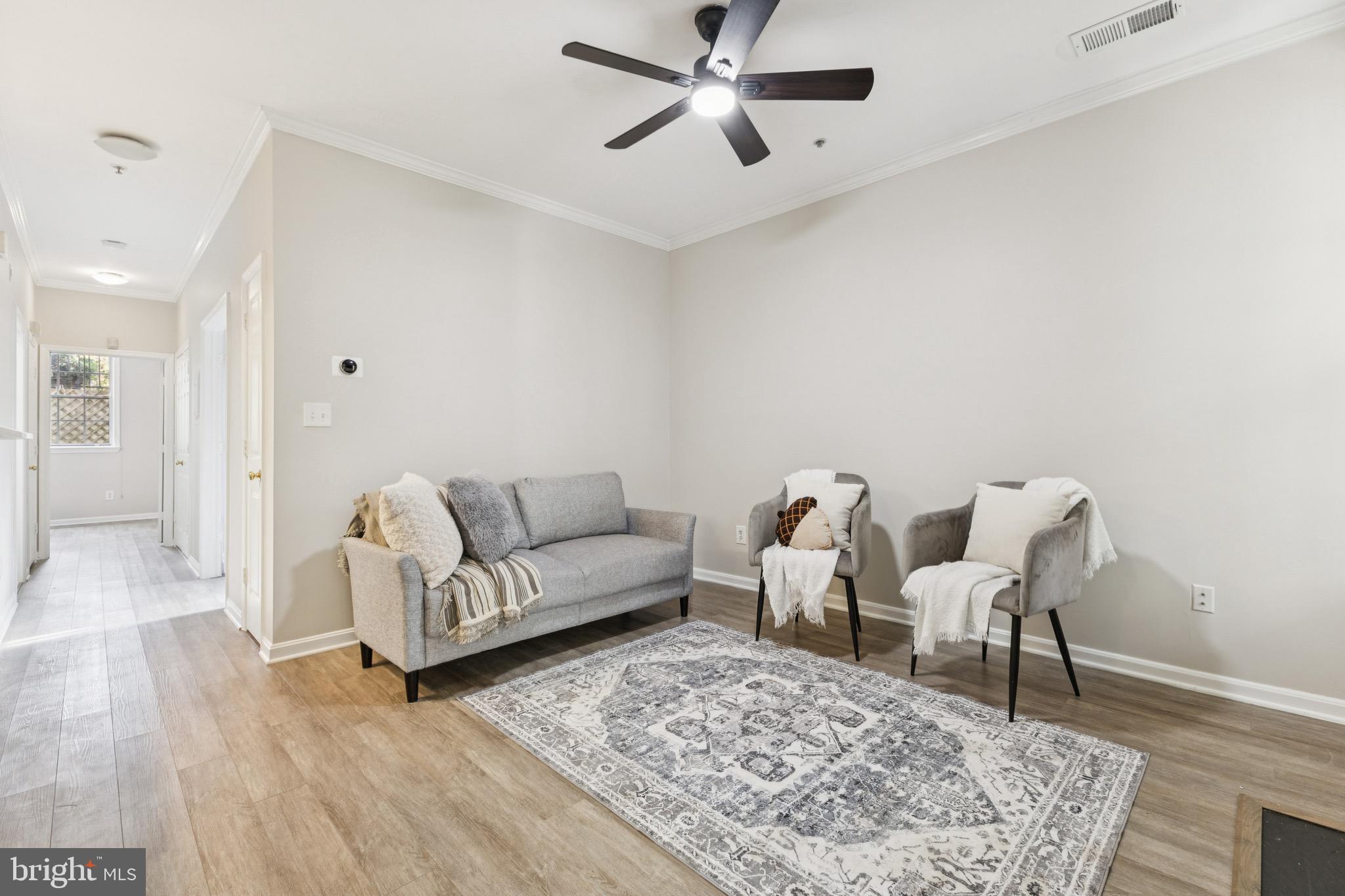 1361 Garden Wall Circle, Unit 701 Reston, VA 20194 - Photo 4 of 15 a living room with furniture and a rug