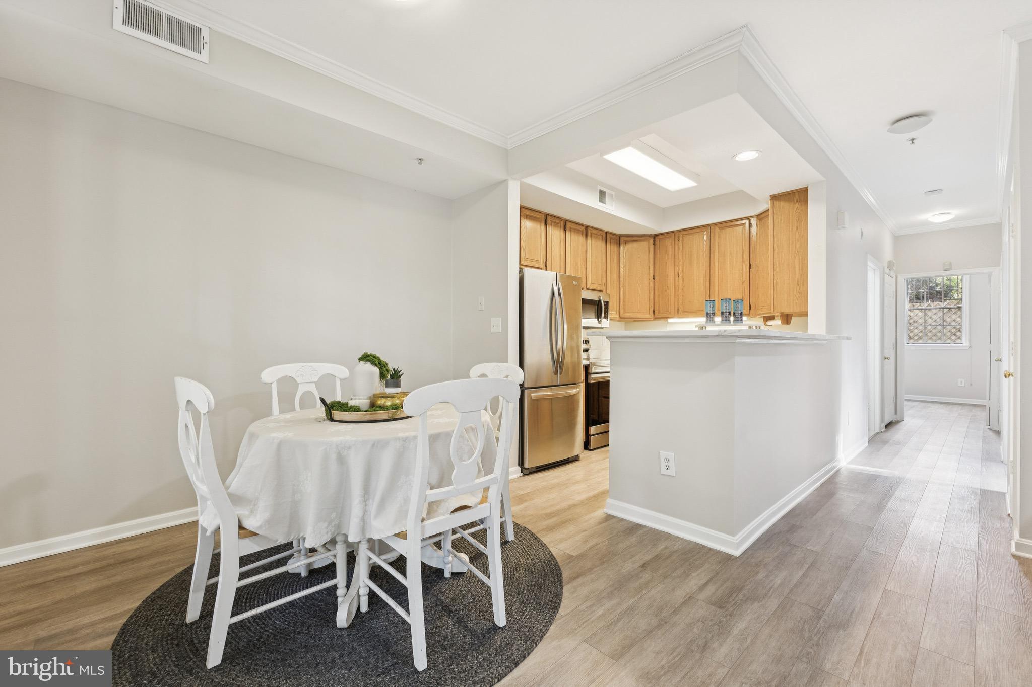 1361 Garden Wall Circle, Unit 701 Reston, VA 20194 - Photo 6 of 15 a view of a dining room with furniture and wooden floor