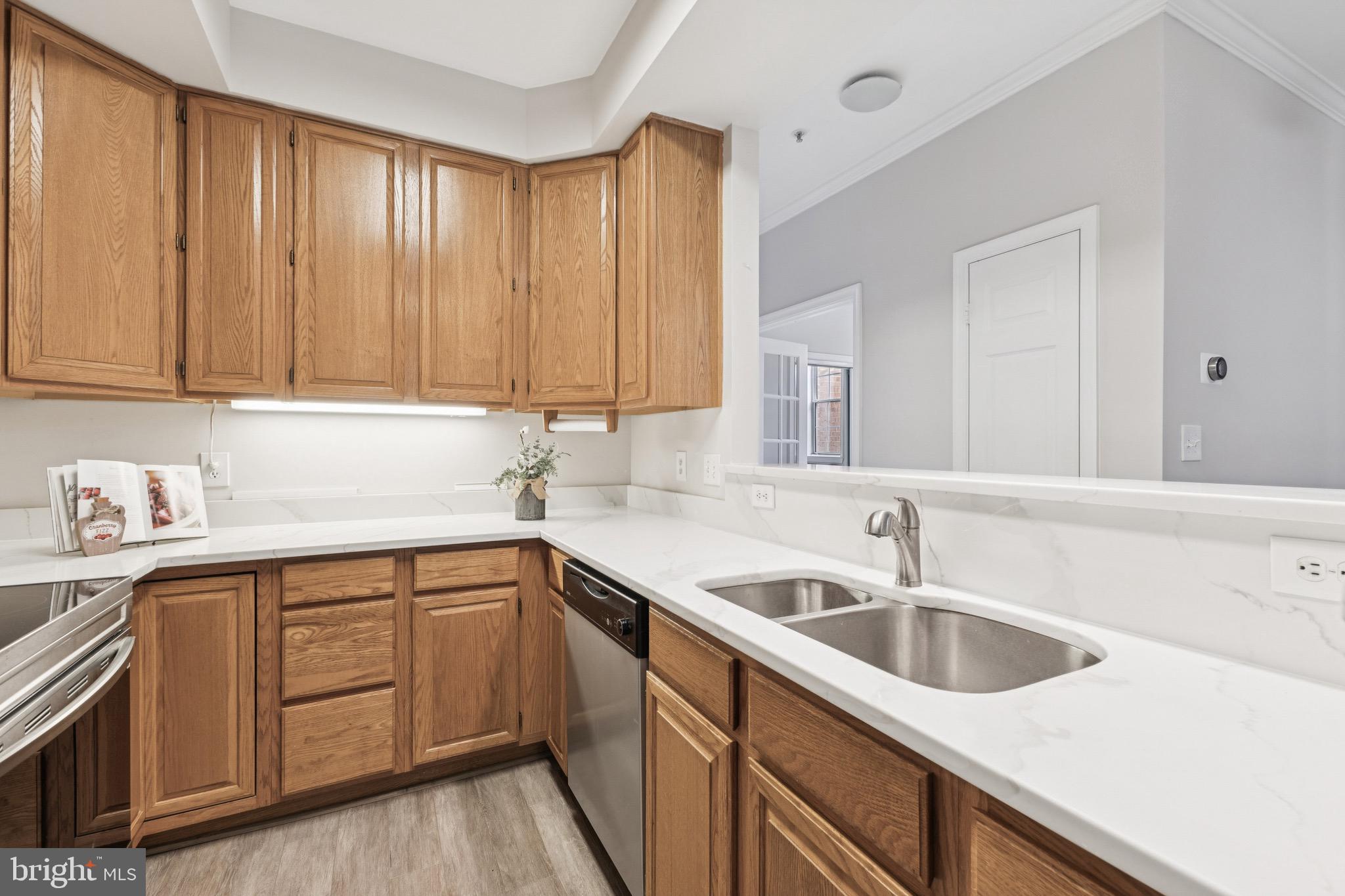 1361 Garden Wall Circle, Unit 701 Reston, VA 20194 - Photo 7 of 15 a kitchen with a sink cabinets and stainless steel appliances
