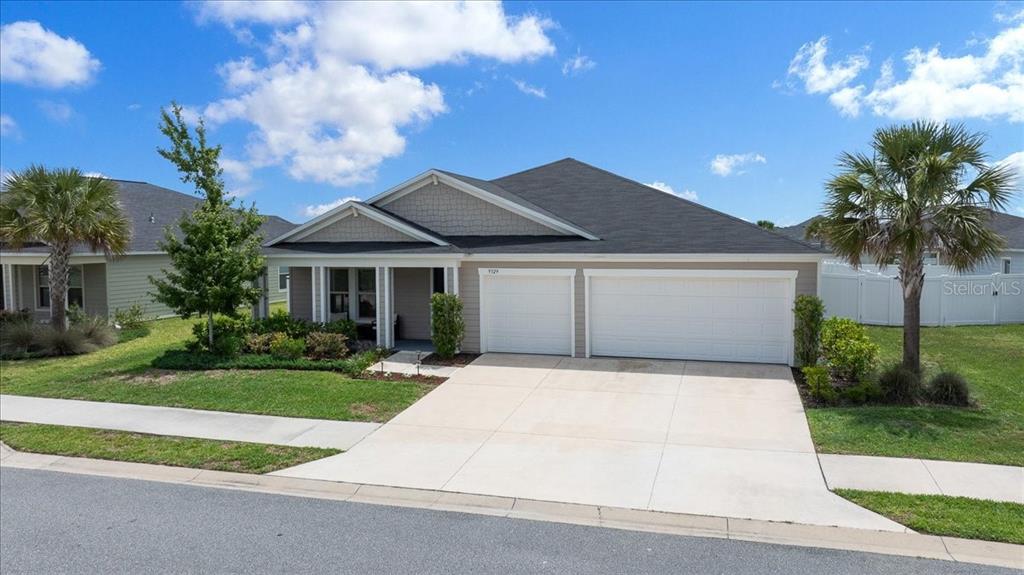 9329 Southwest 57th Terrace Ocala, FL 34476 - Photo 46 of 64 a front view of a house with a yard and garage