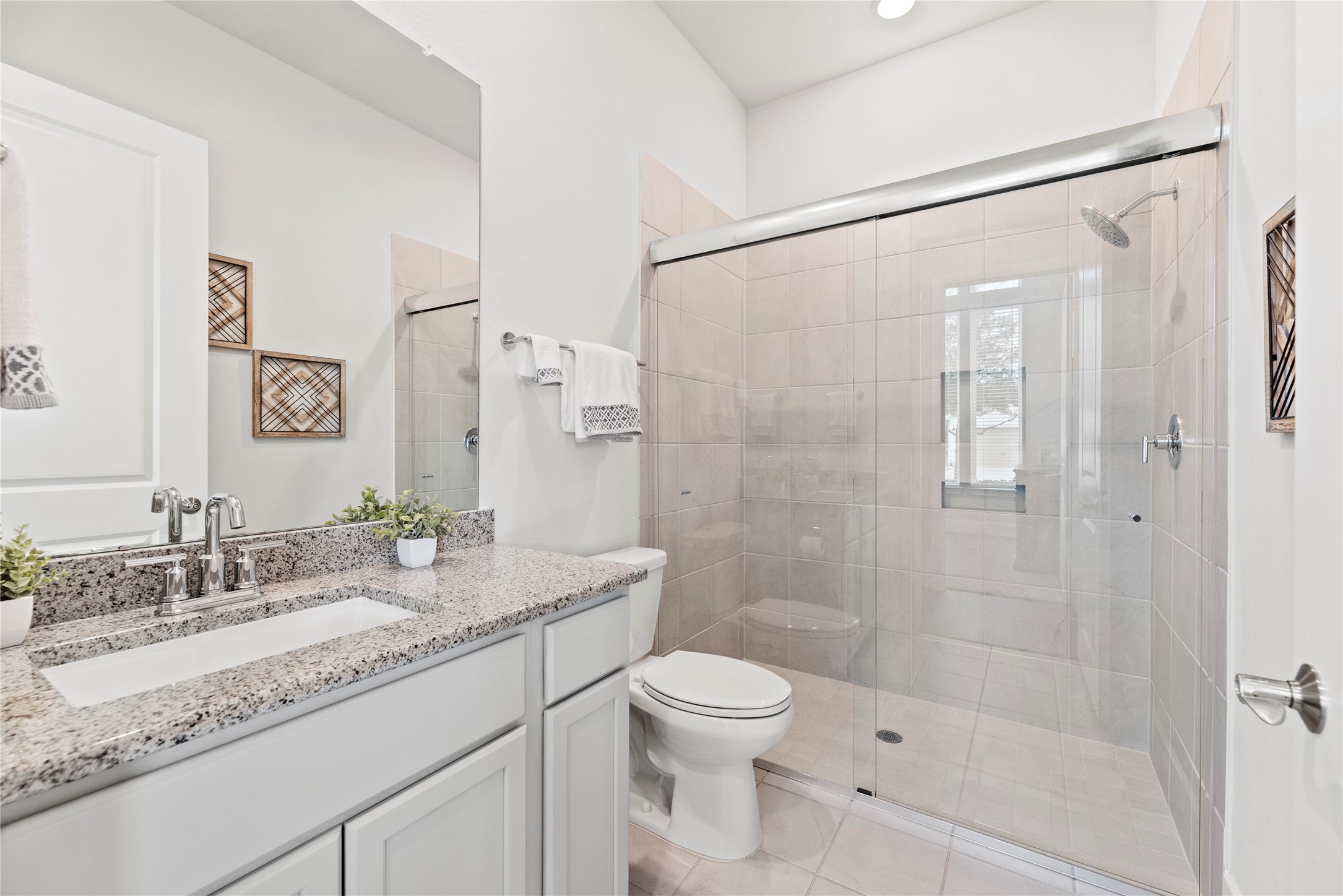 5535 Water Terrace Lane Fulshear, TX 77441 - Photo 11 of 43 a bathroom with a granite countertop sink toilet and shower