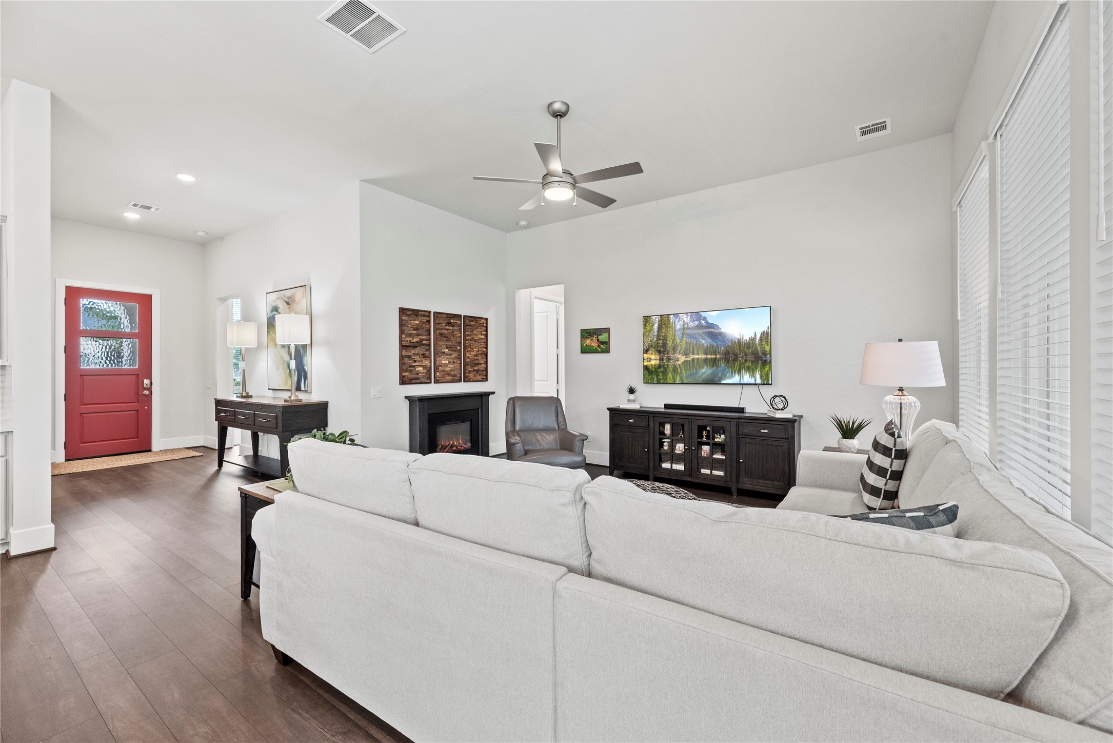 5535 Water Terrace Lane Fulshear, TX 77441 - Photo 14 of 43 a living room with furniture a large window and a chandelier