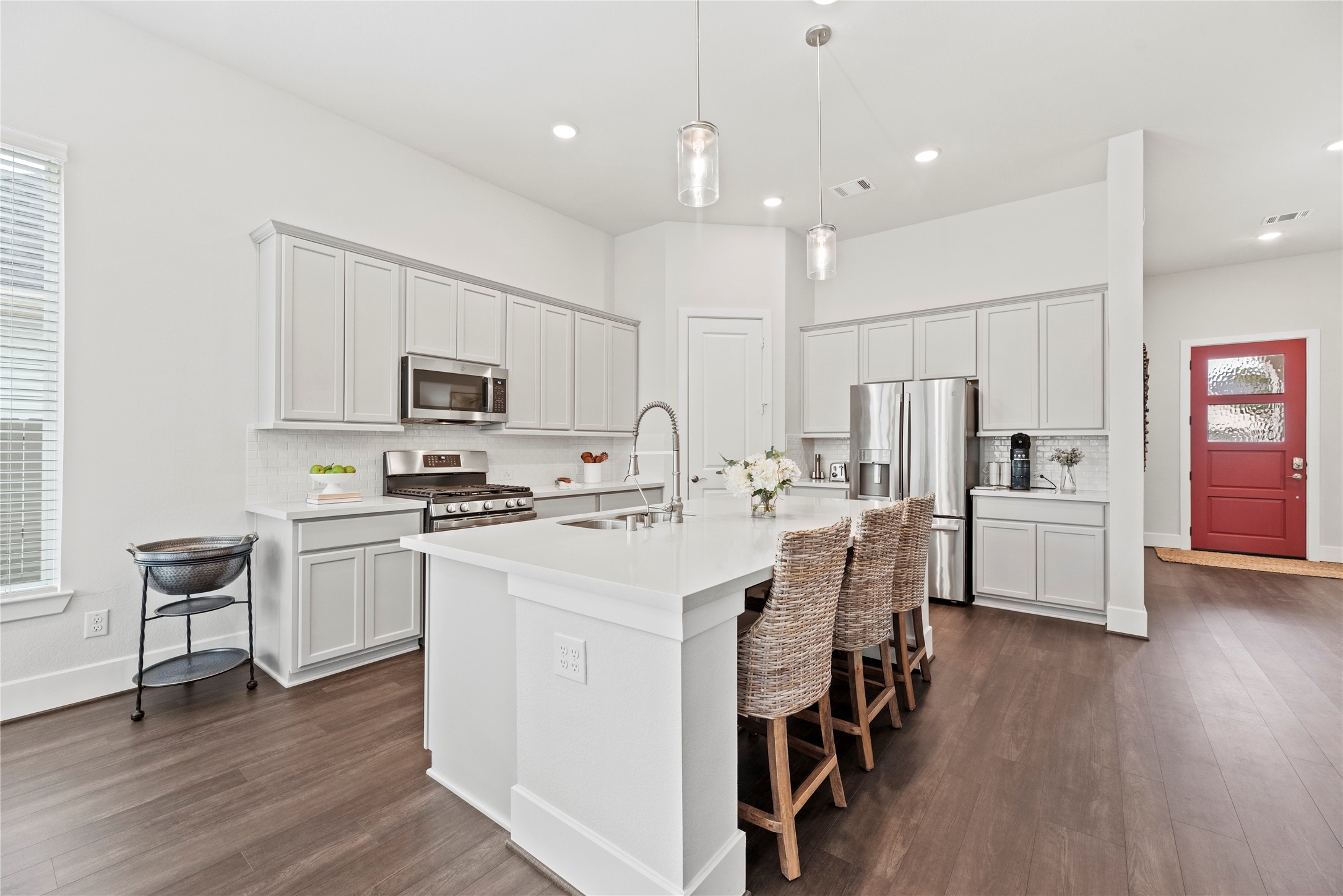5535 Water Terrace Lane Fulshear, TX 77441 - Photo 19 of 43 a kitchen with white cabinets and stainless steel appliances