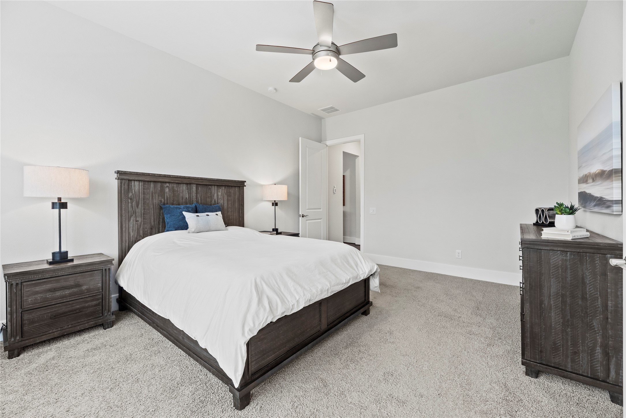 5535 Water Terrace Lane Fulshear, TX 77441 - Photo 23 of 43 a bedroom with a bed and a chandelier