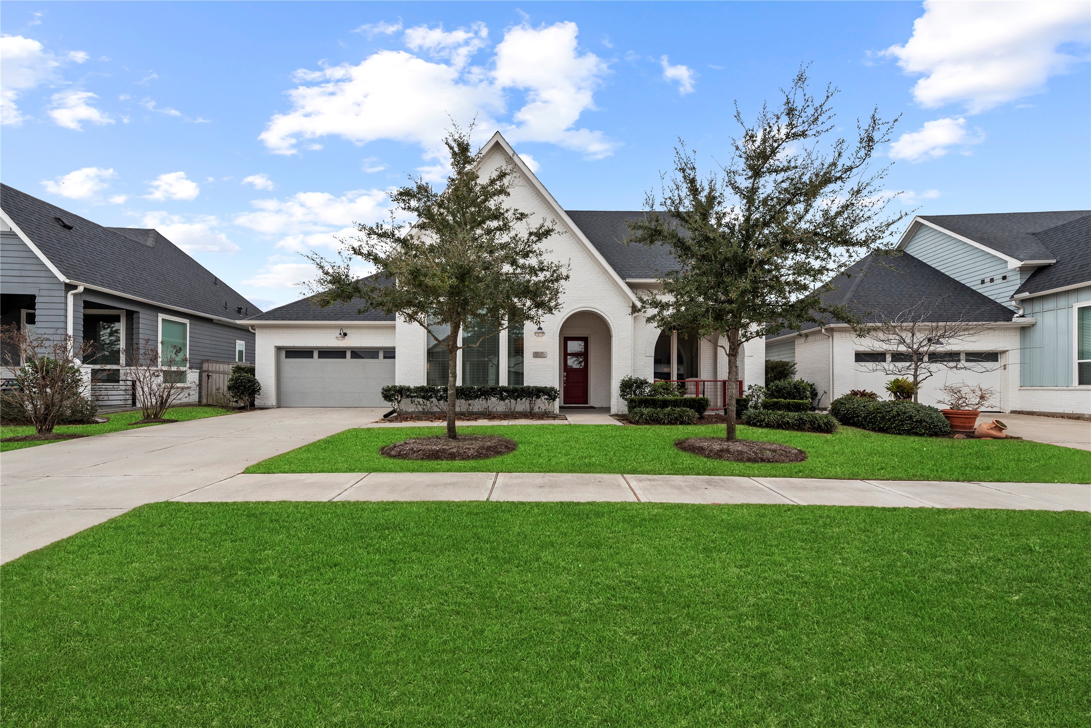 5535 Water Terrace Lane Fulshear, TX 77441 - Photo 3 of 43 a view of a white house in front of a big yard with potted plants
