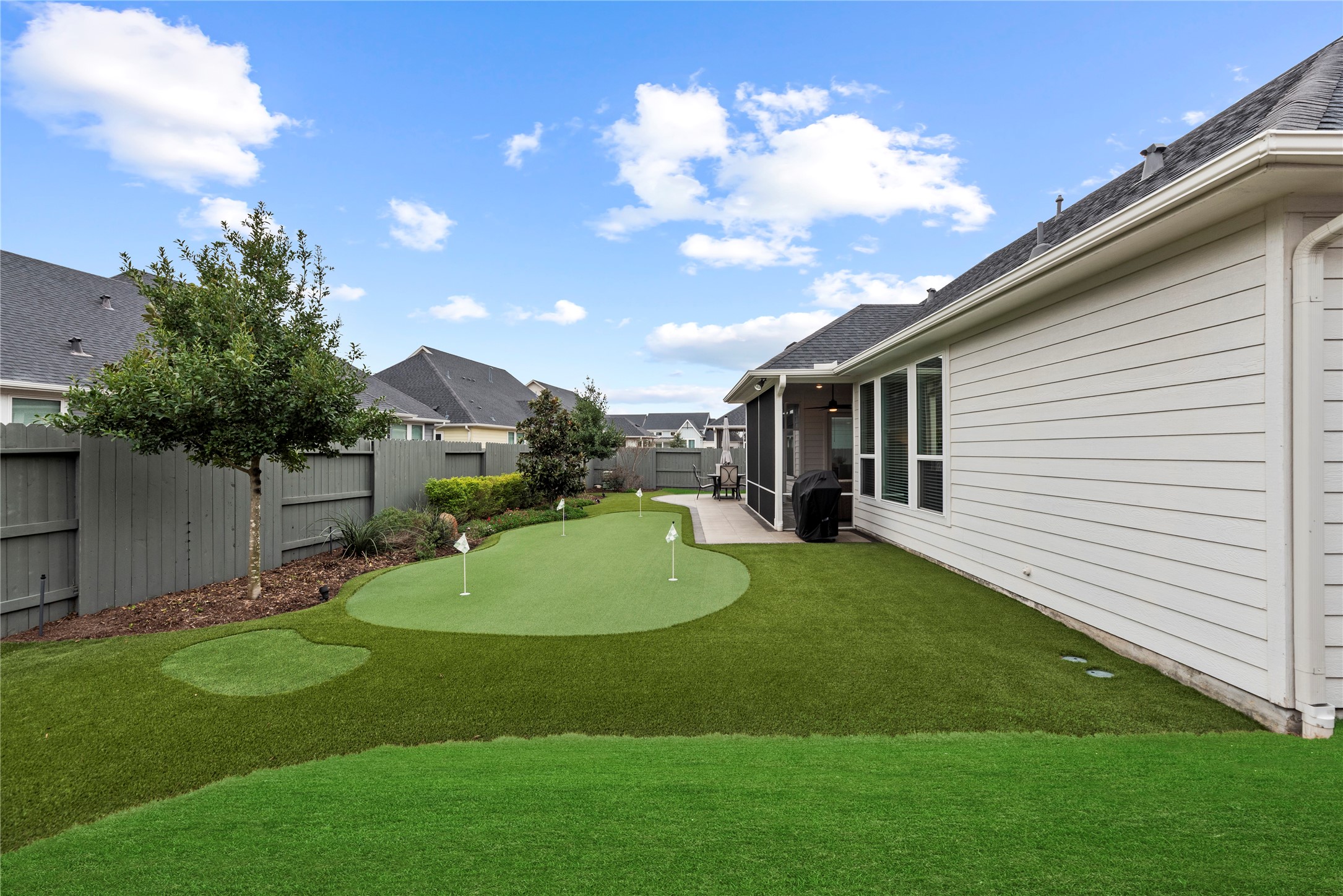 5535 Water Terrace Lane Fulshear, TX 77441 - Photo 33 of 43 a view of a backyard with a garden and entertaining space