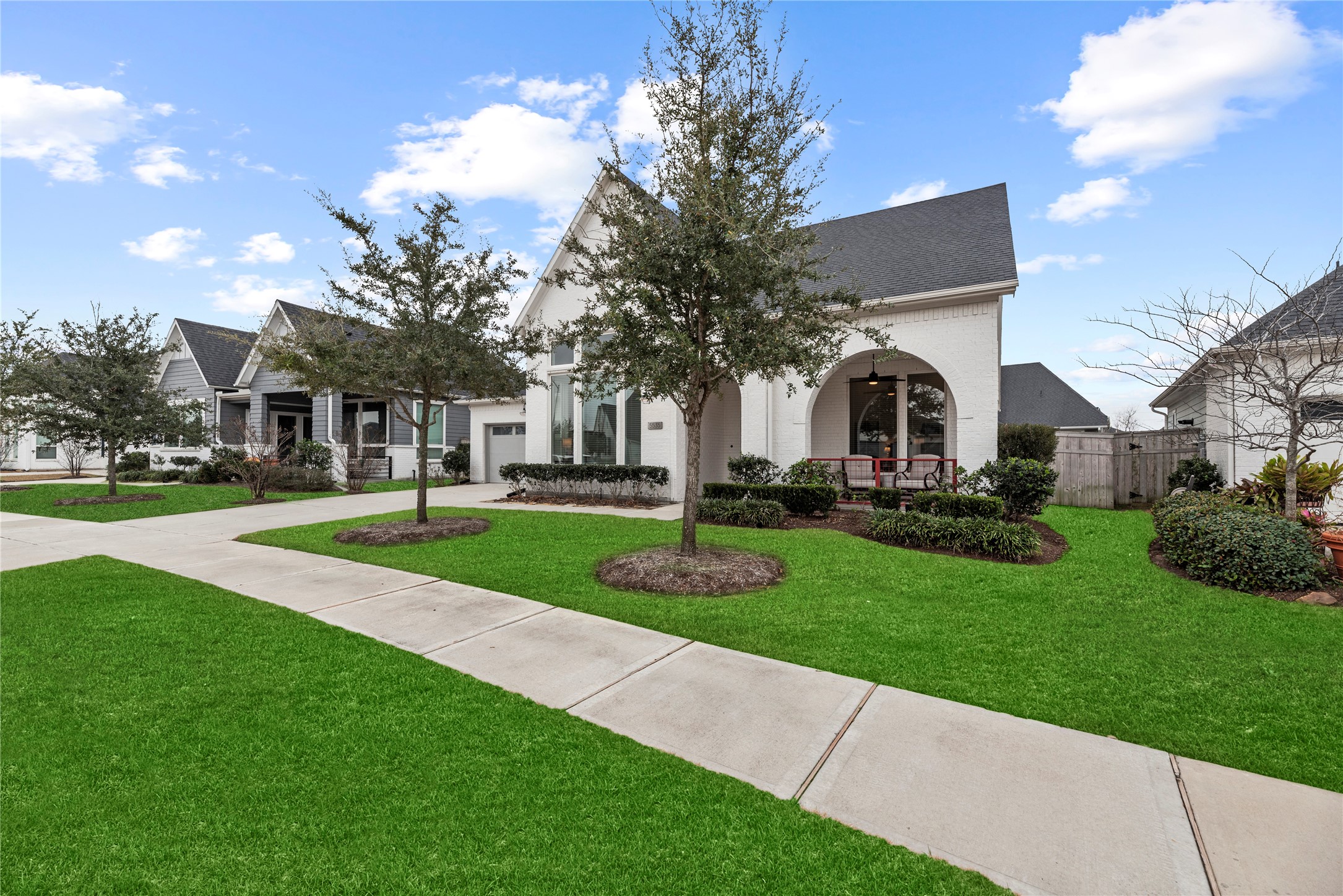 5535 Water Terrace Lane Fulshear, TX 77441 - Photo 4 of 43 a view of a white house with a yard and plants