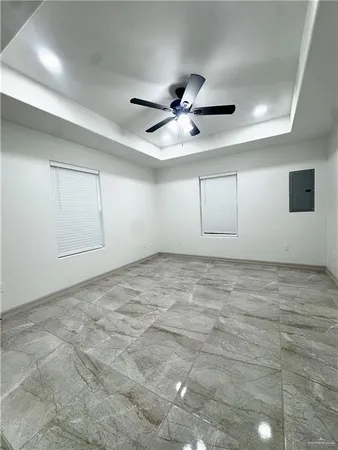 en empty room with ceiling fan and window
