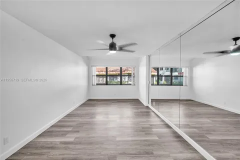 a view of a room with wooden floor
