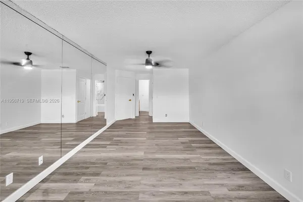 a view of a room with wooden floor