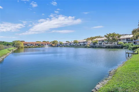 a view of a lake with houses in the back