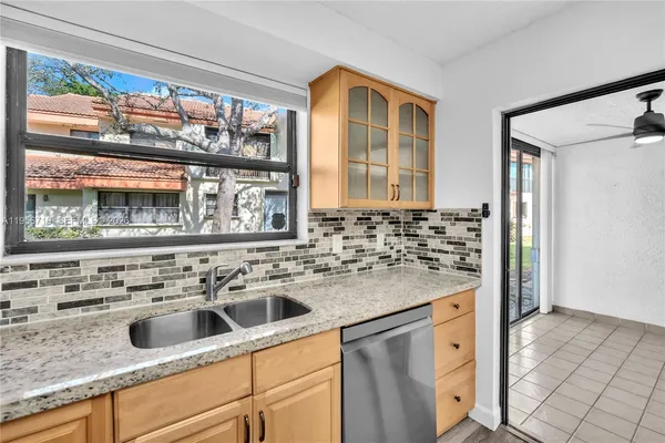 a kitchen with a sink stove and cabinets