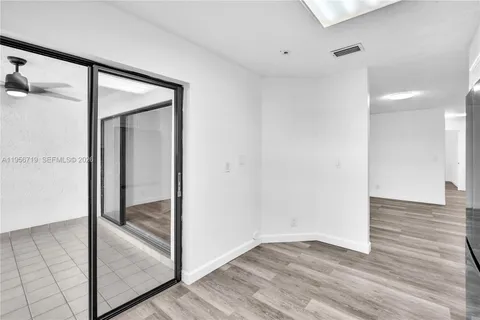a view of hallway with wooden floor