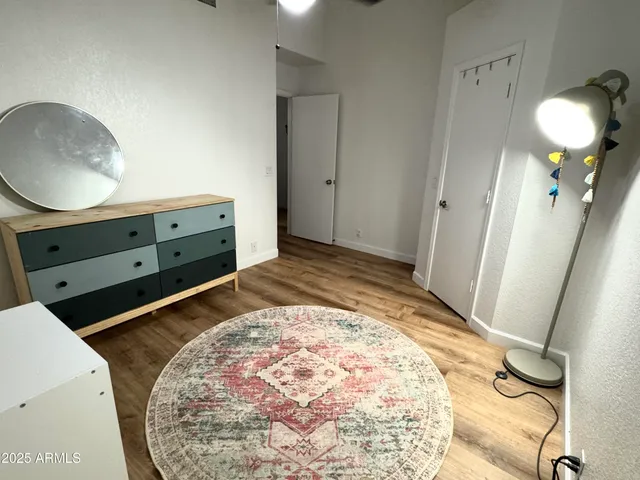 a bedroom with a bed and a mirror