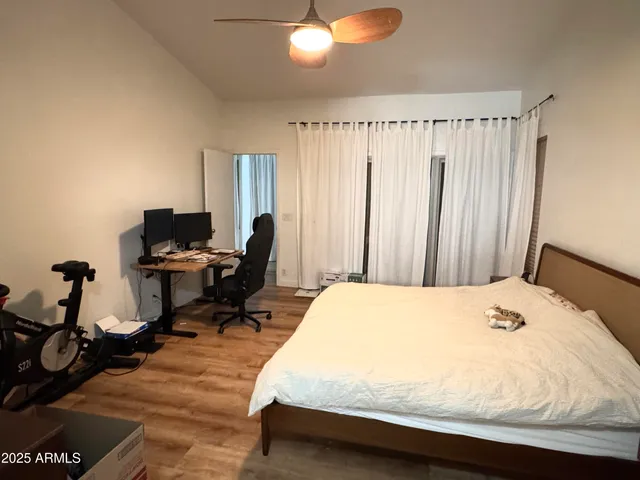 a bedroom with a bed and a chandelier