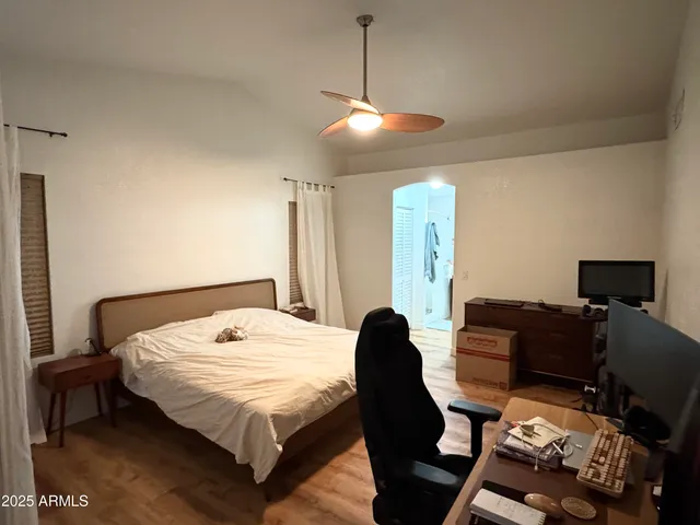 a bedroom with a bed window and couch