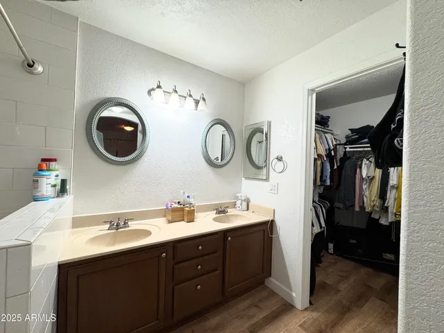 a bathroom with a double vanity sink and a mirror