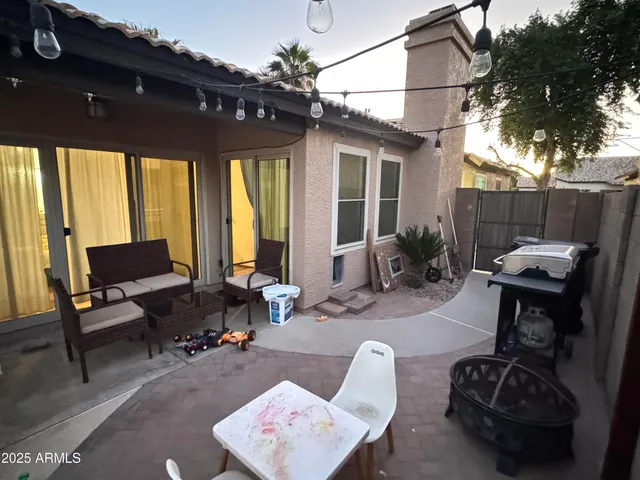 a backyard of a house with outdoor seating