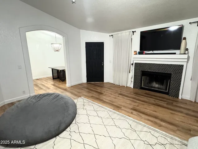 a living room with a fireplace and a flat screen tv
