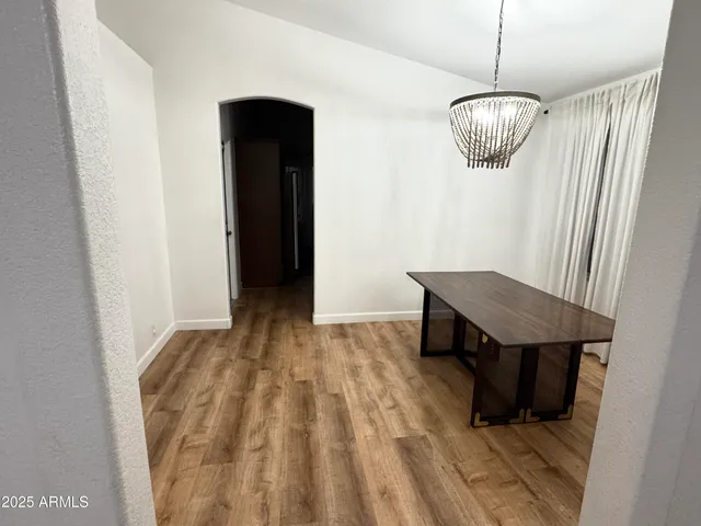 a view of a room with a table and chairs