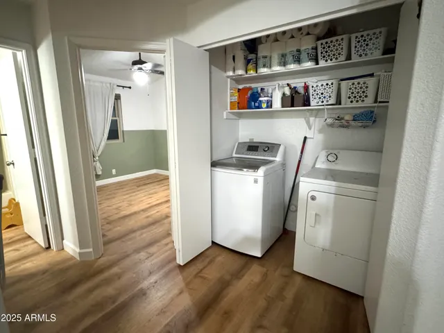 a view of kitchen and utility room with wooden floor