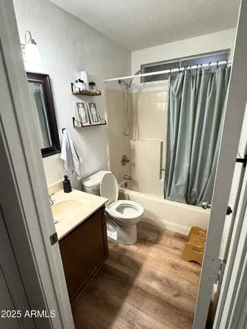 a bathroom with a sink a toilet a mirror and shower