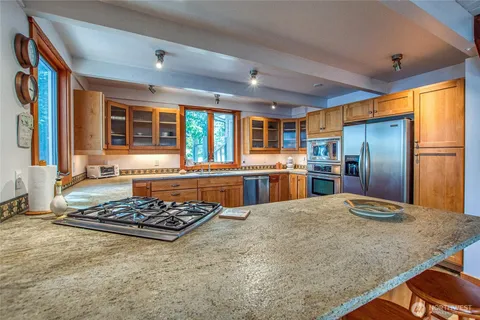 a kitchen with a stove and a window