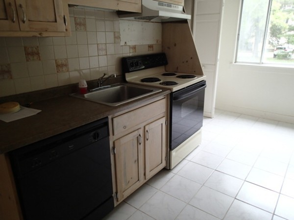 139 Winter Street, Unit 1 Framingham, MA 01702 - Photo 4 of 11 a kitchen with a sink cabinets and a stove