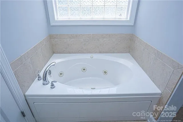 wooden floor fireplace and windows in an empty room