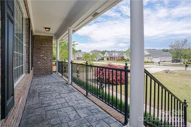 a view of a deck with a floor to ceiling window and a yard