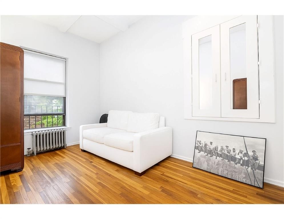 41 Jane Street, Unit 5B Manhattan, NY 10014 - Photo 4 of 8 a living room with furniture and a window
